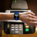 Smart Watch on woman's arm with Contactless payment and NFC technology application on screen with Electronic Reader.