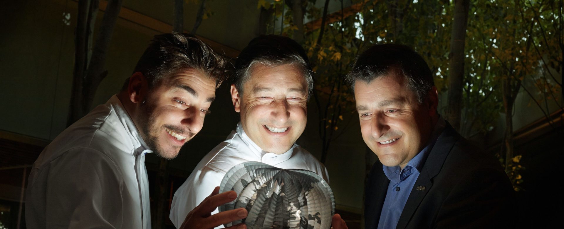 Fotografía de los hermanos Roca con un globomundo luminoso