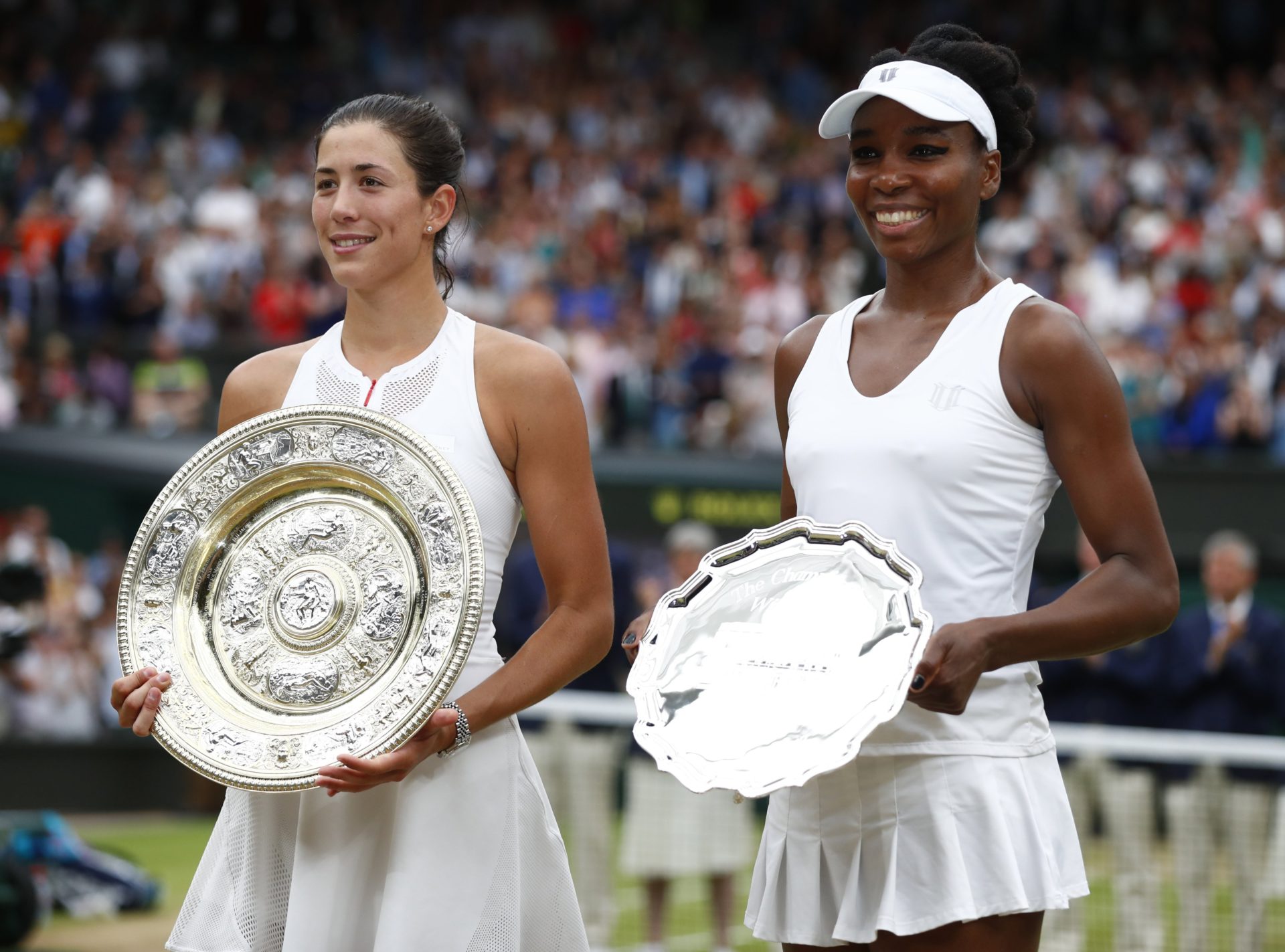 Garbiñe Muguruza posa con el trofeo de campeona de Wimbledon junto a Venus Williams