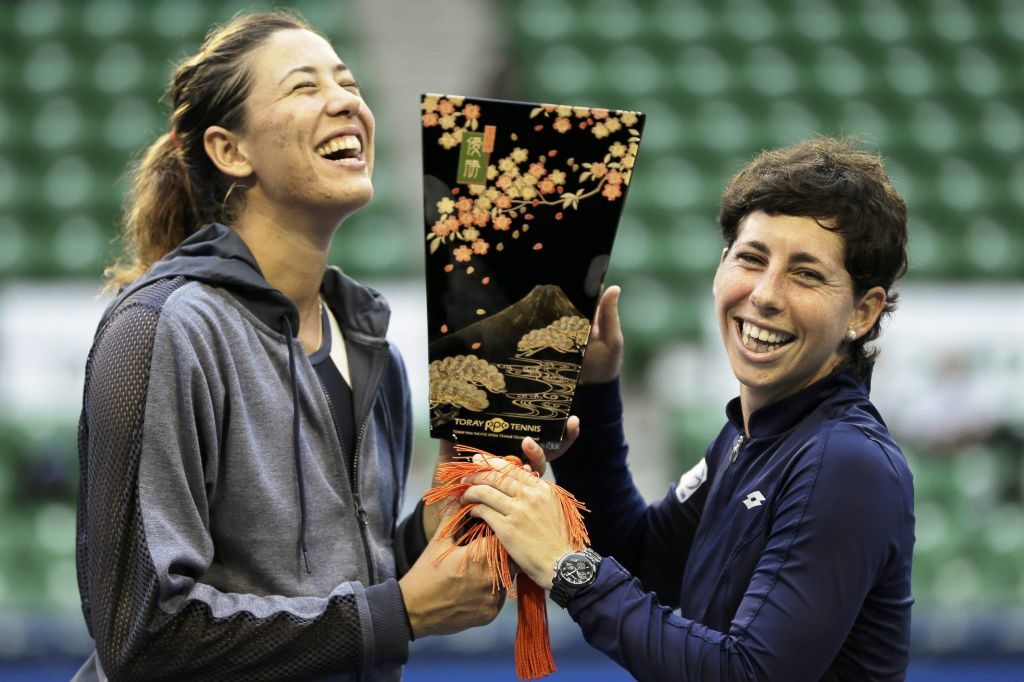 Garbiñe Muguruza y Carla Suárez celebran el trofeo de Tokio 2015