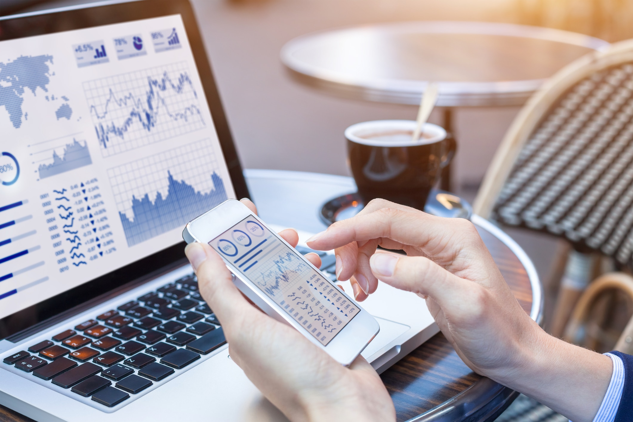 Businesswoman analyzing stock market KPI with BI, computer, smartphone screen Businesswoman analyzing stock market KPI with BI, computer, smartphone screen