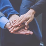 bbva Business-team holding hands on top of each other bbva Business-team holding hands on top of each other