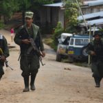 Image of Armed FARC fighters on a trek across one of the Colombian municipalities without State presence.