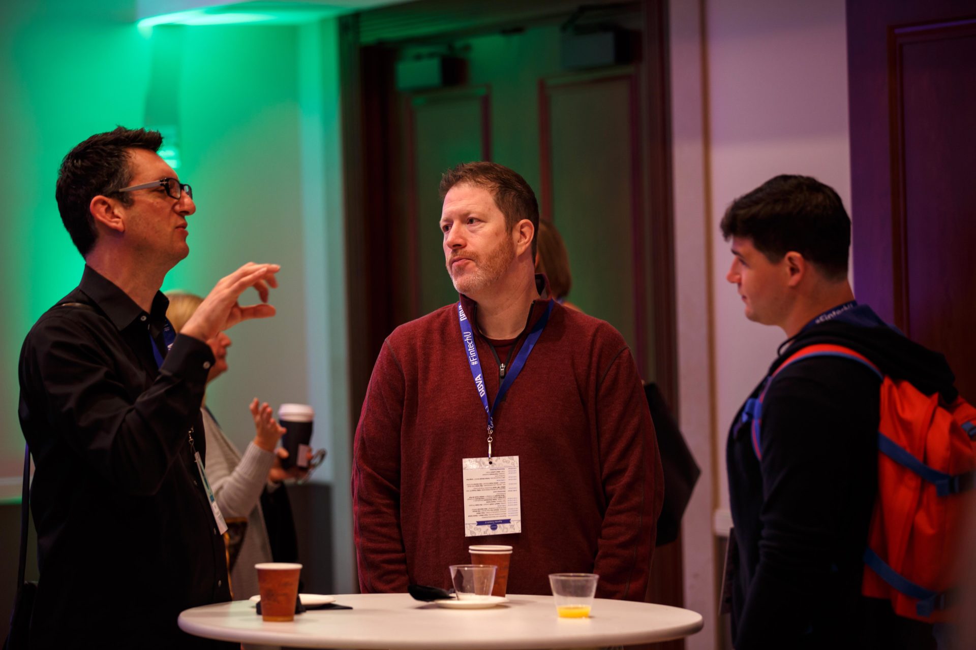 A photo of Fintech University attendees interacting during a coffee and networking session.