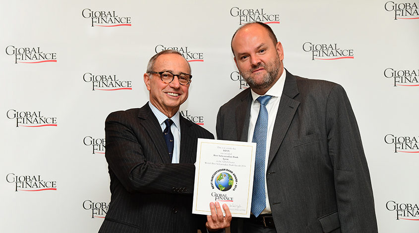 Alexis Thompson, Head of Global Securites Services, receiving the Best Custodian in Spain awards certificates from Global Finance Publisher and Editorial Director, Joseph Giarraputo.