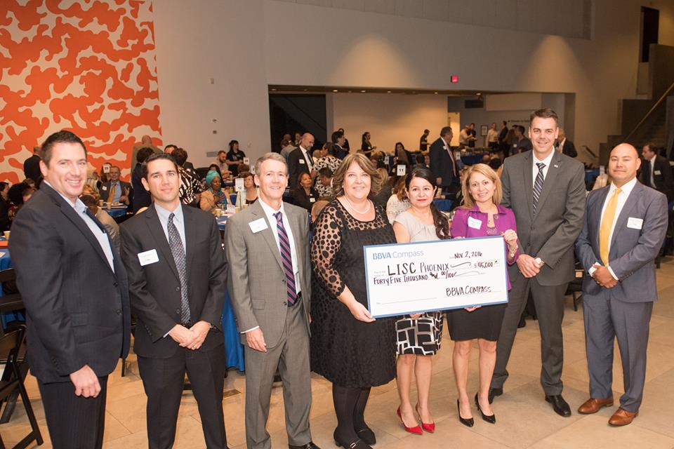 Members of LISC Phoenix and BBVA Compass pose with the $45,000 grant check at the 2016 LISC Phoenix Annual Breakfast.