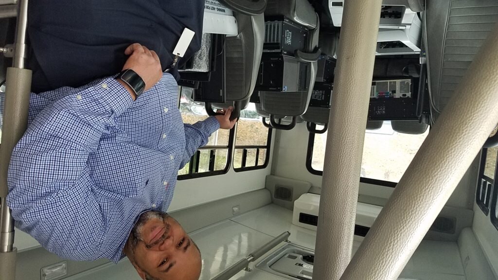 A photo of BBVA Compass Birmimgham Chapter Volunteer Kevin Cunningham loading computers and laptops for donation to the Houston Authority Birmingham District