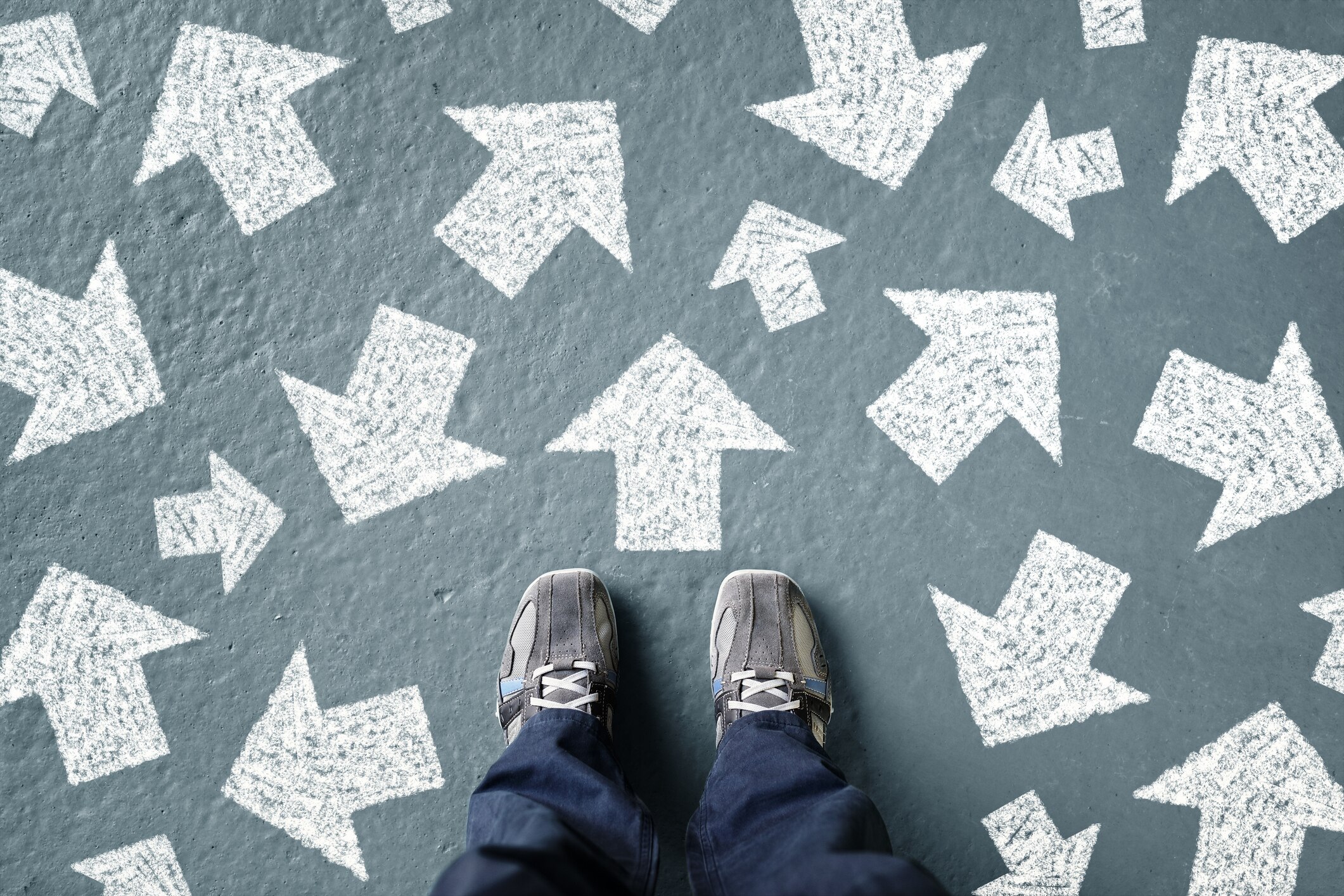 Body-image-Using-mental-models-to-make-better-decisions Taking decisions for the future man standing with many direction arrow choices, left, right or move forward