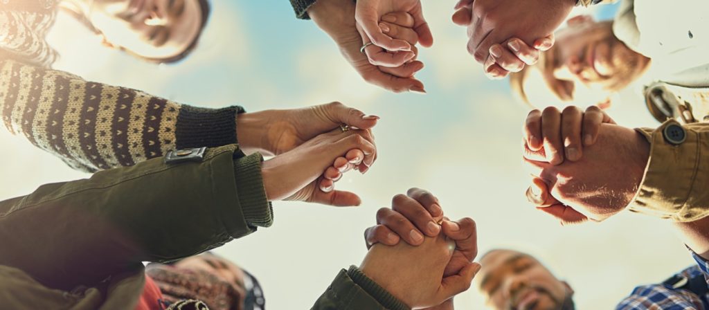 Grasped hands in a circle