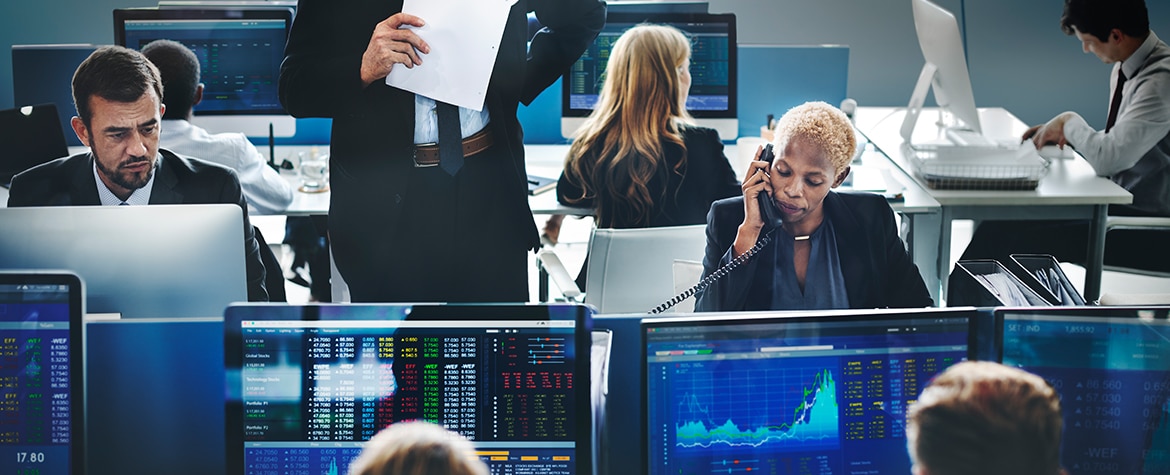 Picture of workspace, computers, market charts, currencies, BBVA